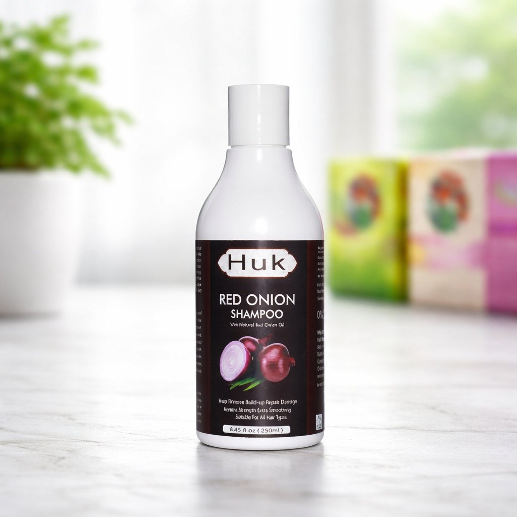 Huk Red Onion Shampoo bottle for hair repair and smoothing on a marble surface.