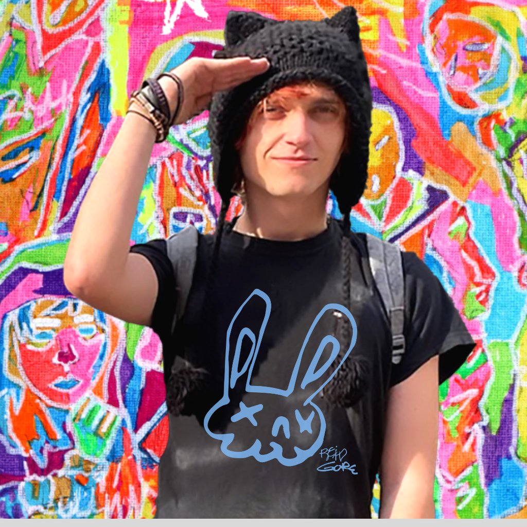 Reid Gorecki wearing a Reid Gore shirt and saluting in a cat hat