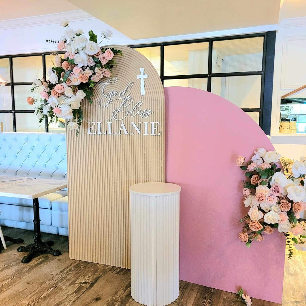 Baptism backdrop in pink and beige at Nodo Restaurant on St Clair