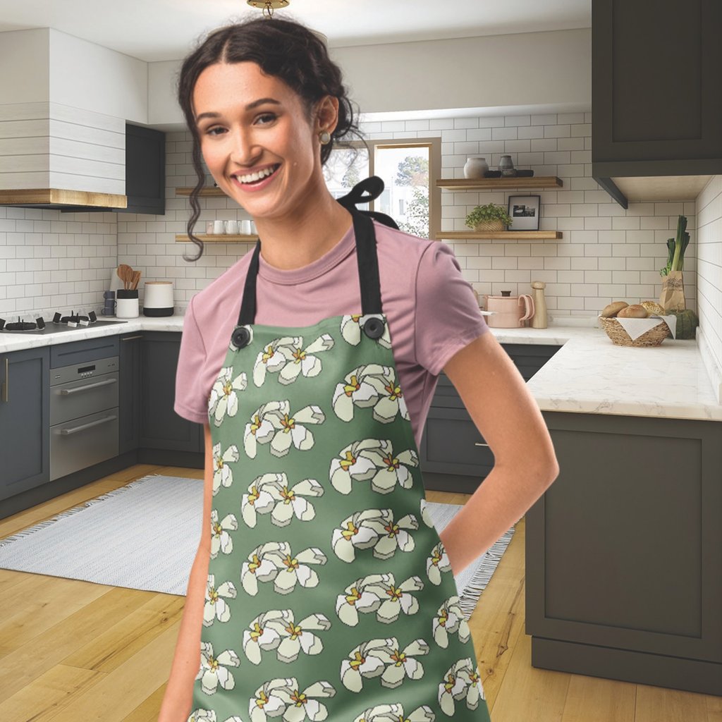 Woman wearing a plumeria patern aprondesign by Mara Branco in a modern kitchen.