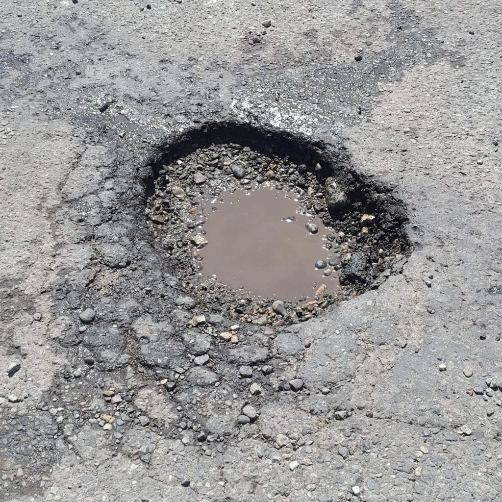 Pothole that needs repaired on parking lot job