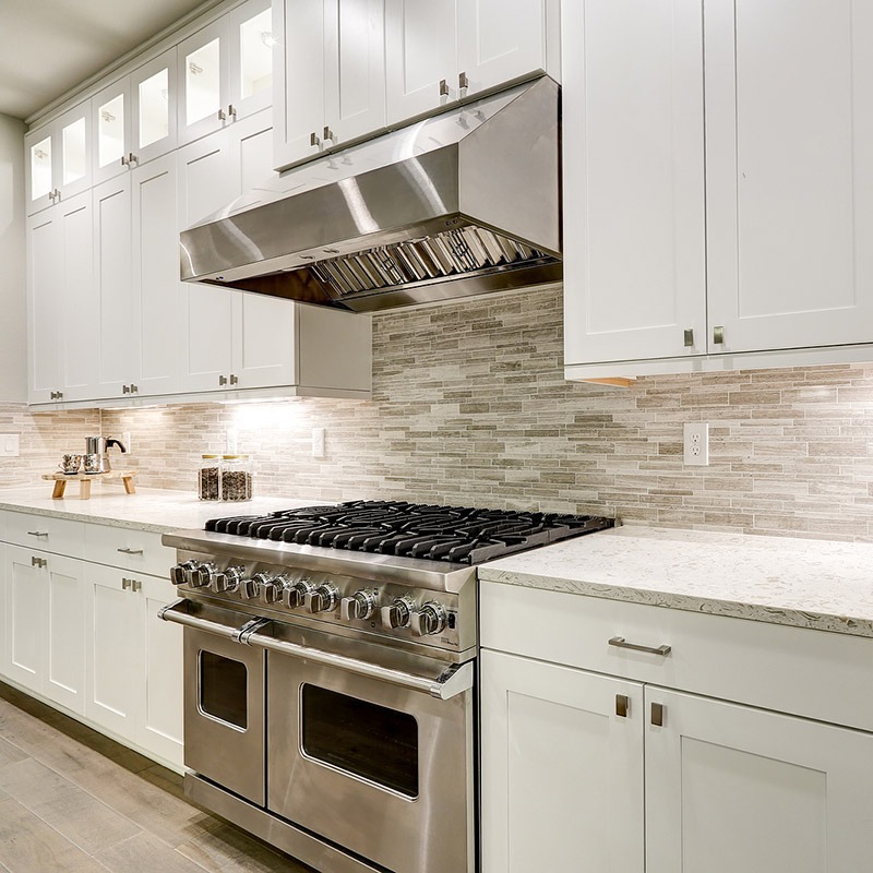 a kitchen with a stove top oven and a range hood