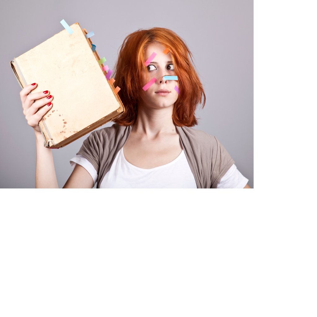 Photo of a woman holding a manuscript. Both the book and her face have colored sticky tabs on them