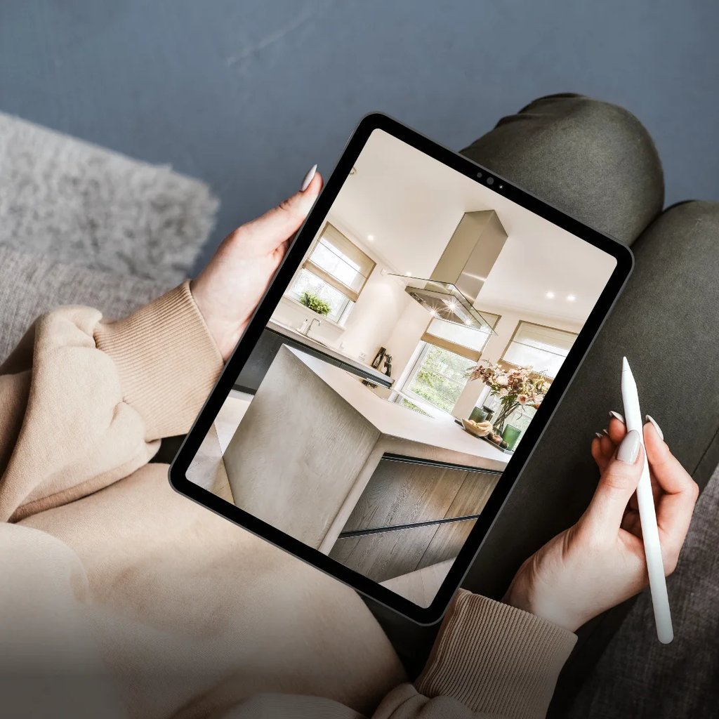 A person viewing a high-quality real estate virtual tour on a tablet, showcasing a modern kitchen