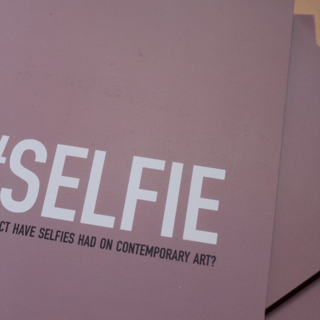 a pink book, the cover says '#Selfie: What impact have selfies had on contemporary art?'