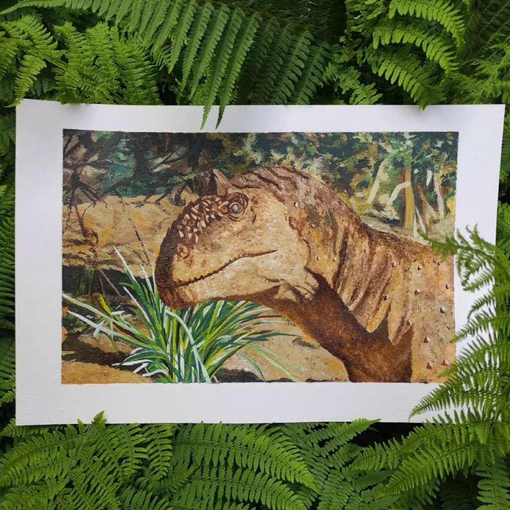Profile view of a Majungasaurus head painted in acrylics, set against a green landscape.