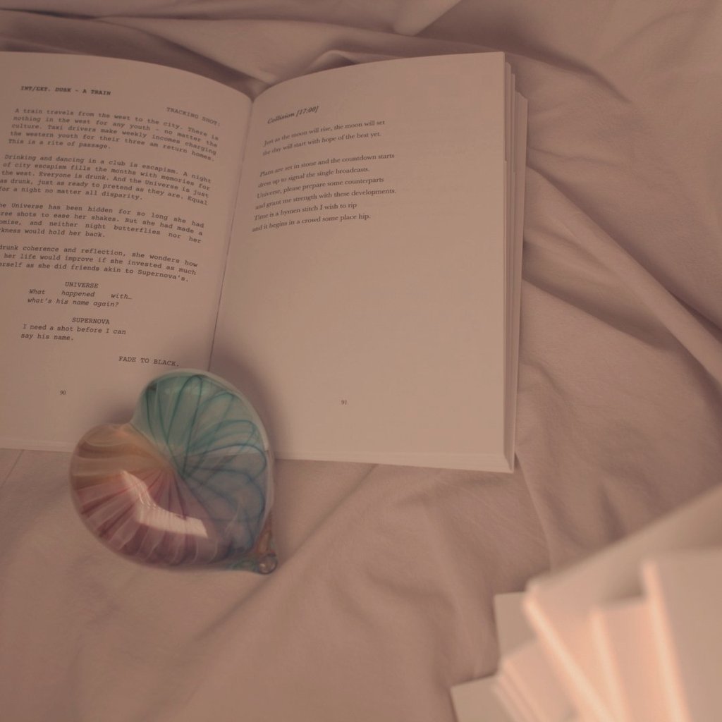 J.R. Sonder's book held apart with a rainbow glass heart.