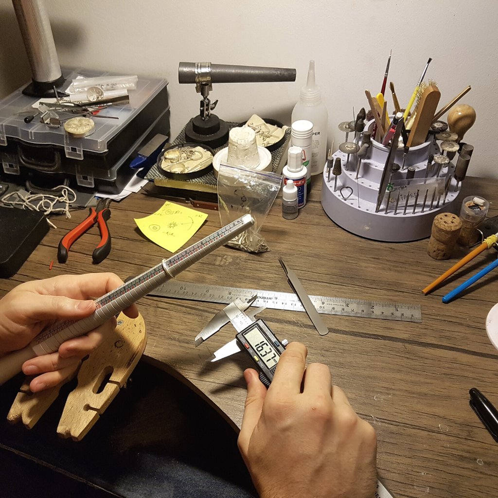 a person holding a ruler and measuring ruler