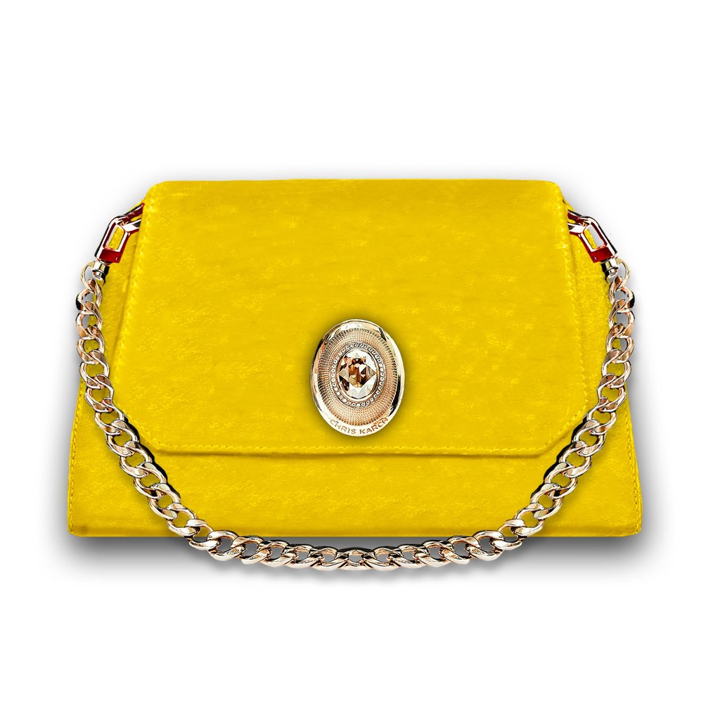 Elegant yellow leather shoulder bag with gold chain strap and ornate metal buckle clasp.