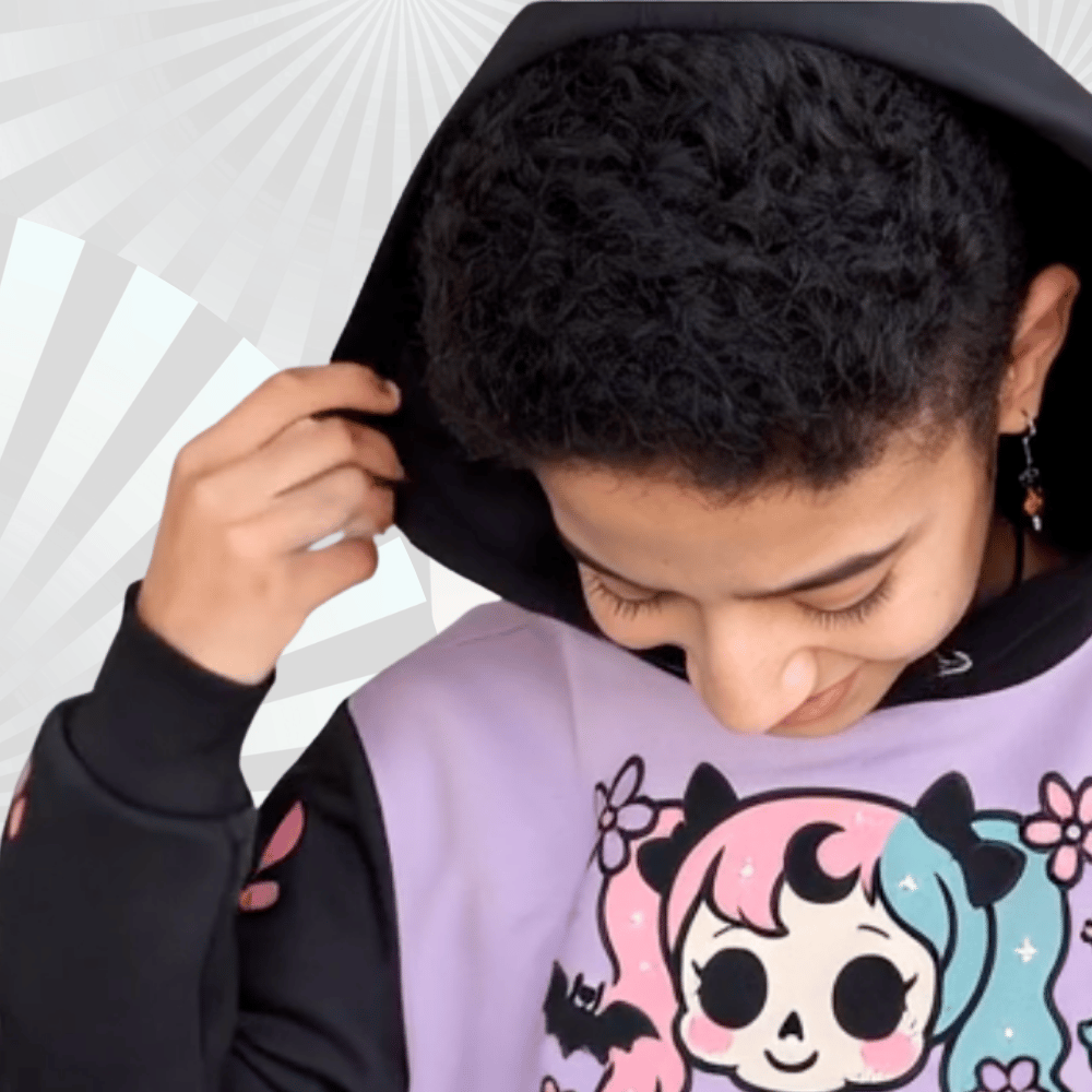 a young girl with a black hair and a pastel goth hoodie