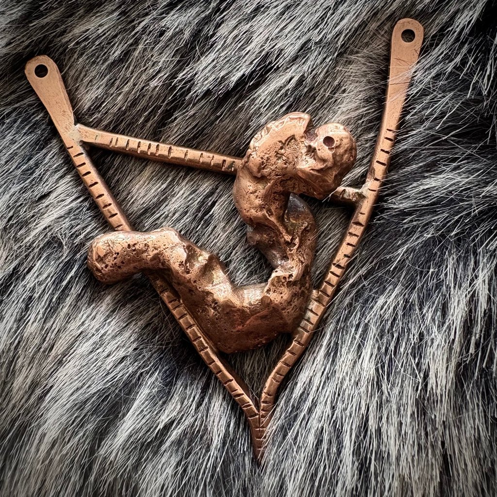 A pendant piece made from textured and reticulated copper