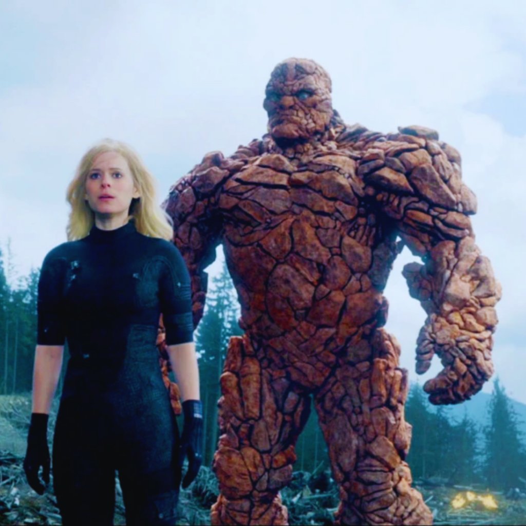 a woman in a black wetsuit standing next to a giant thing