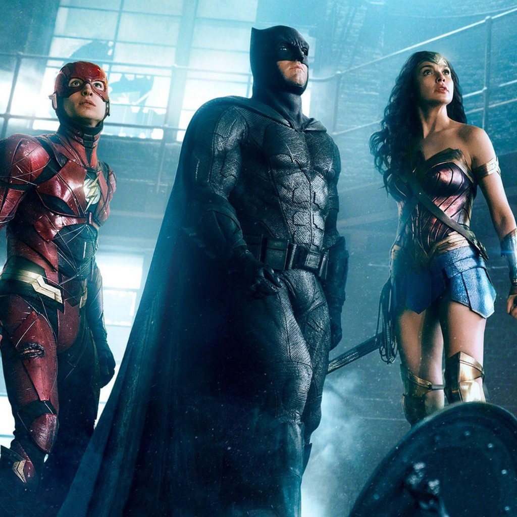 a group of people standing around a man in a suit and a woman in a