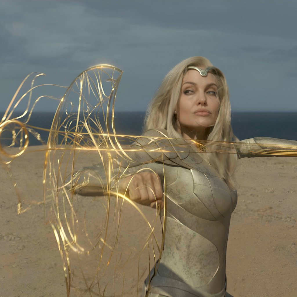 a woman in a silver dress with a sword