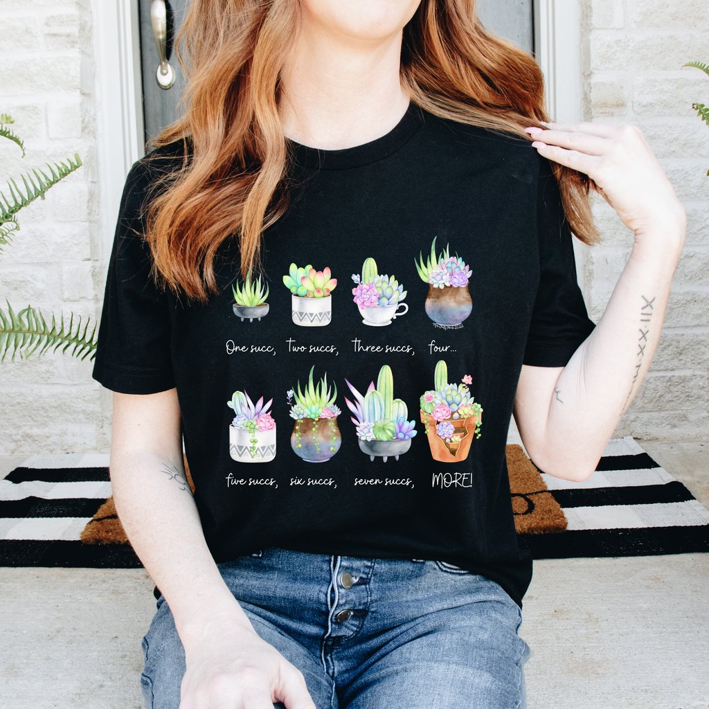 Girl wearing black succulent graphic tee with multiple illustrated succulent pots across the front.