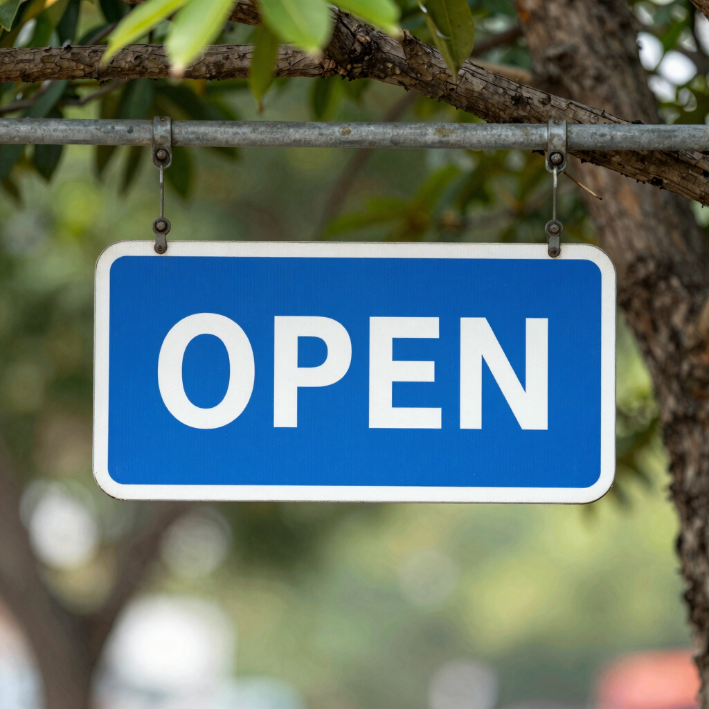 brown and white open signage on green grasses