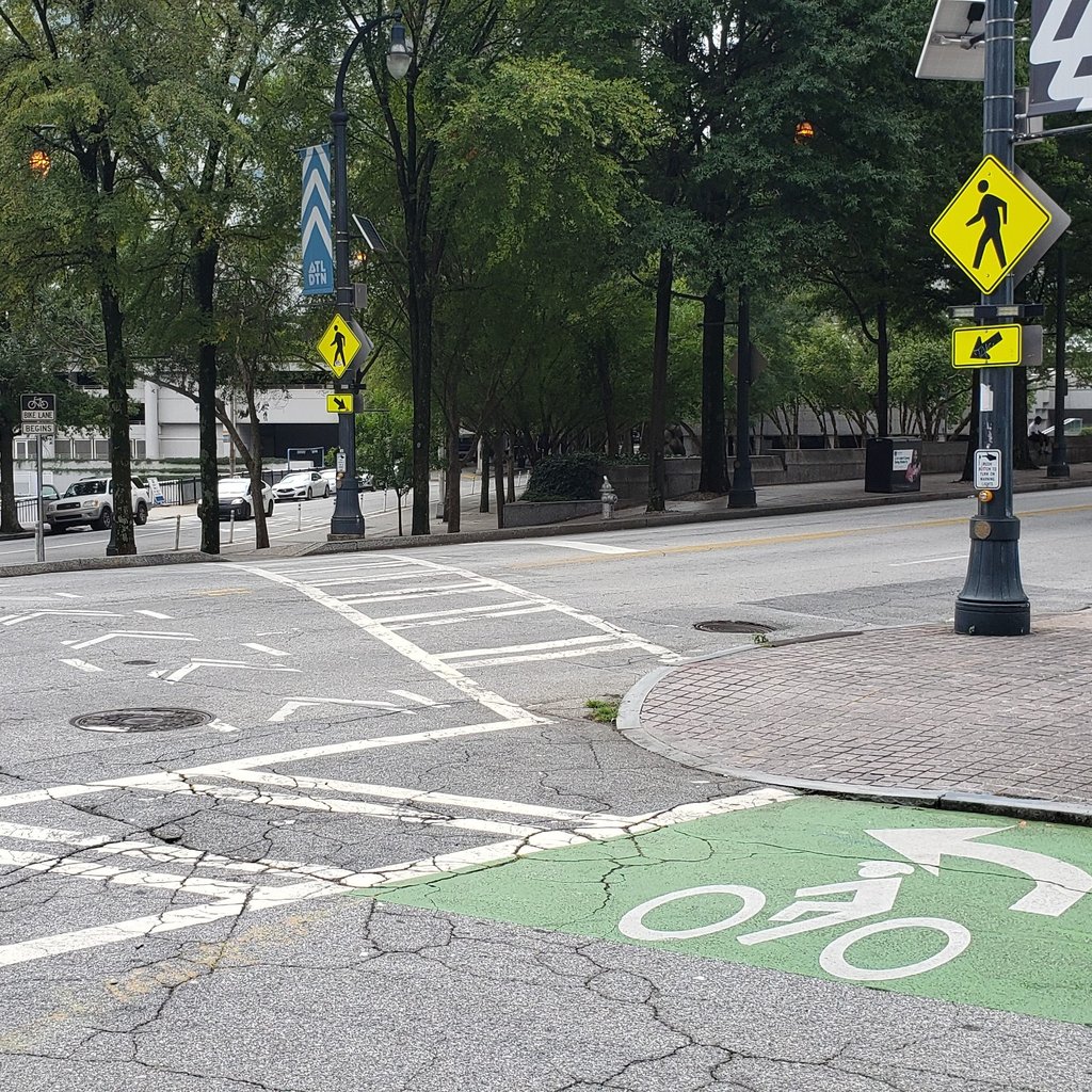 Two-stage bicycle turn queue box with crosswalk and RRFB