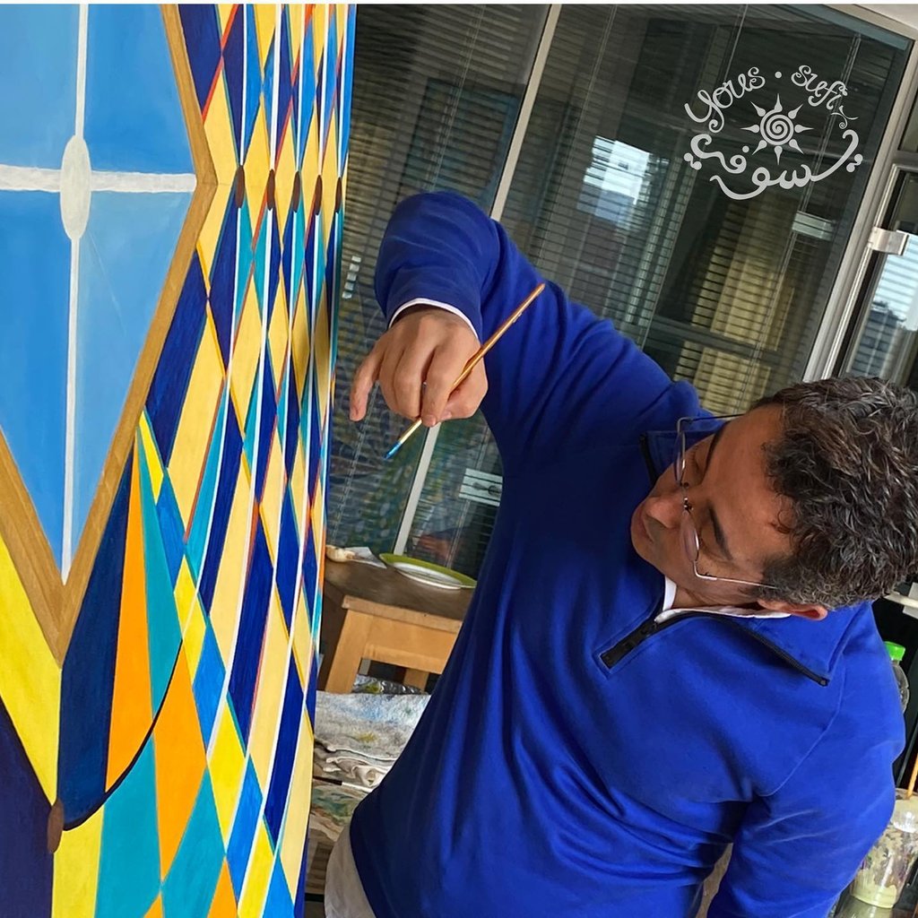 artist Yous holding painting brush and painting