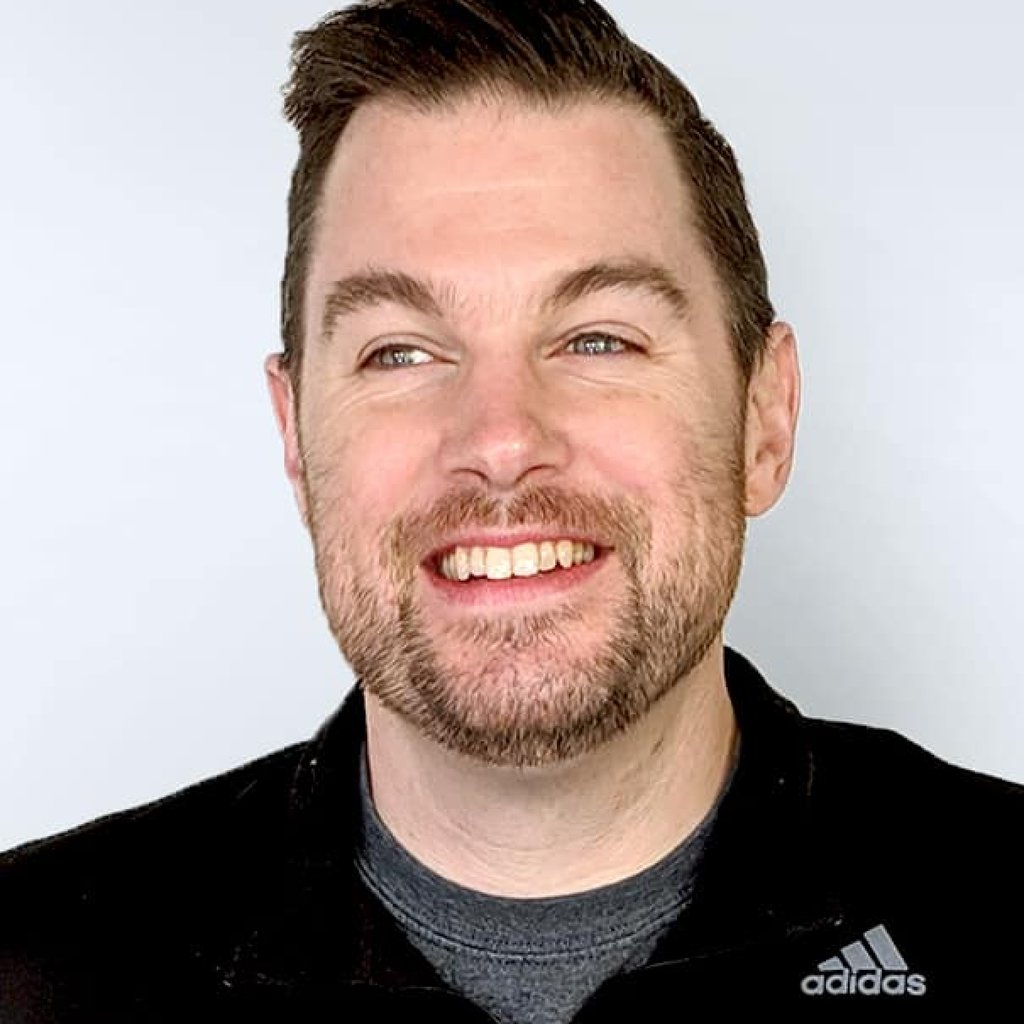 Damon Gaumont, a man with a beard wearing a black polo over a grey shirt