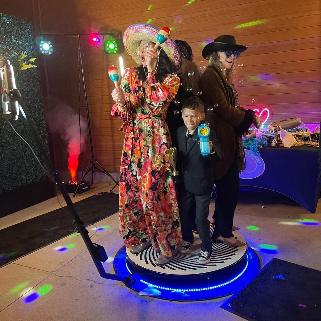 Family on a 360 video booth having fun
