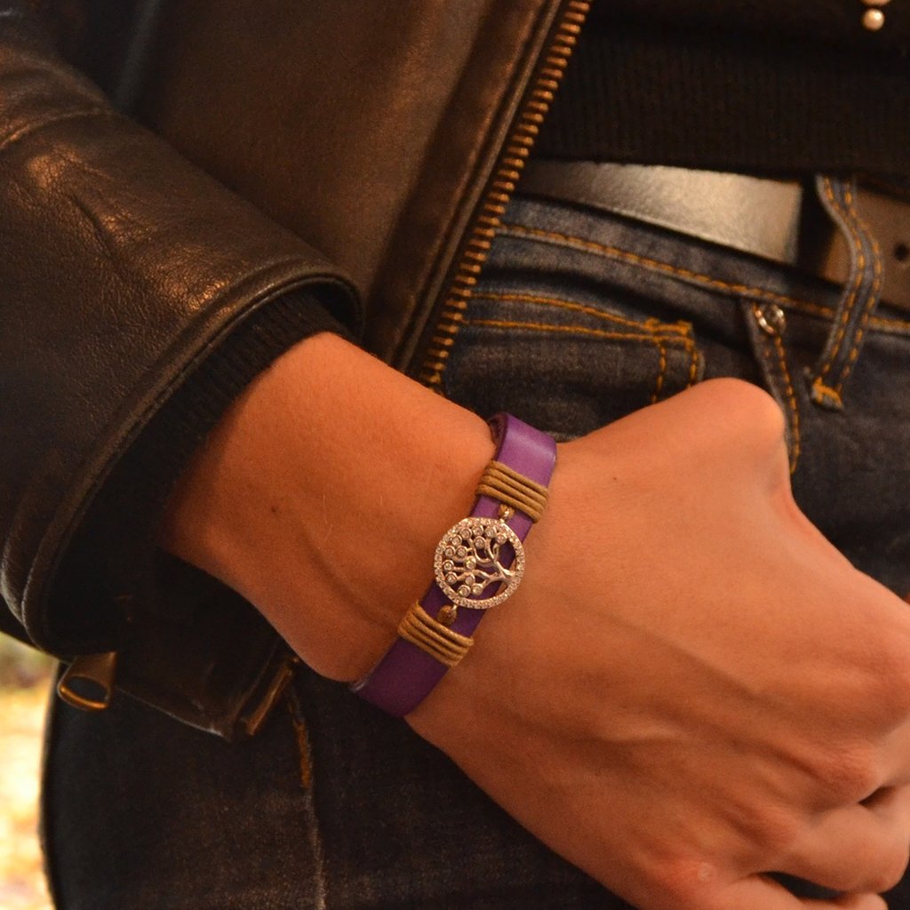 a woman's wrist wearing a purple bracelet