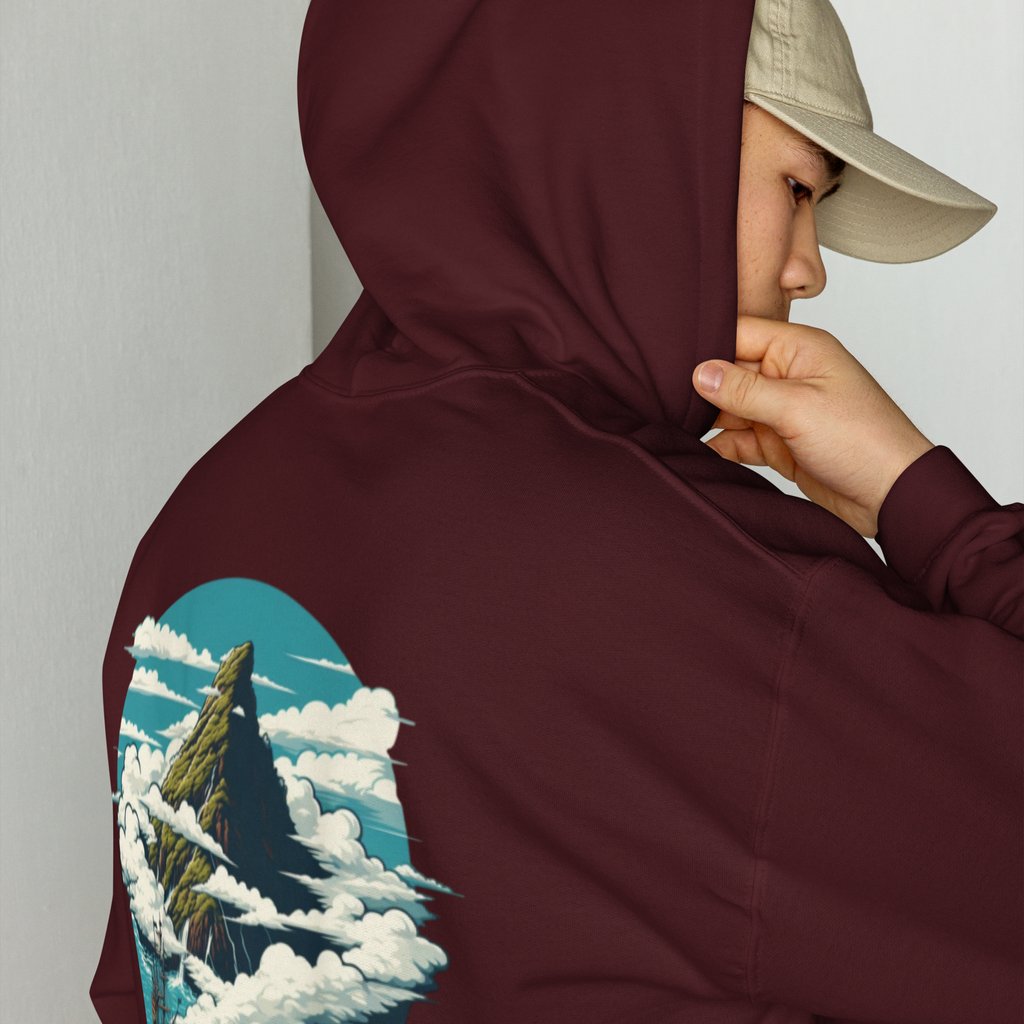 A man wearing a maroon pullover hoodie with a mountain landscape graphic print on the back.