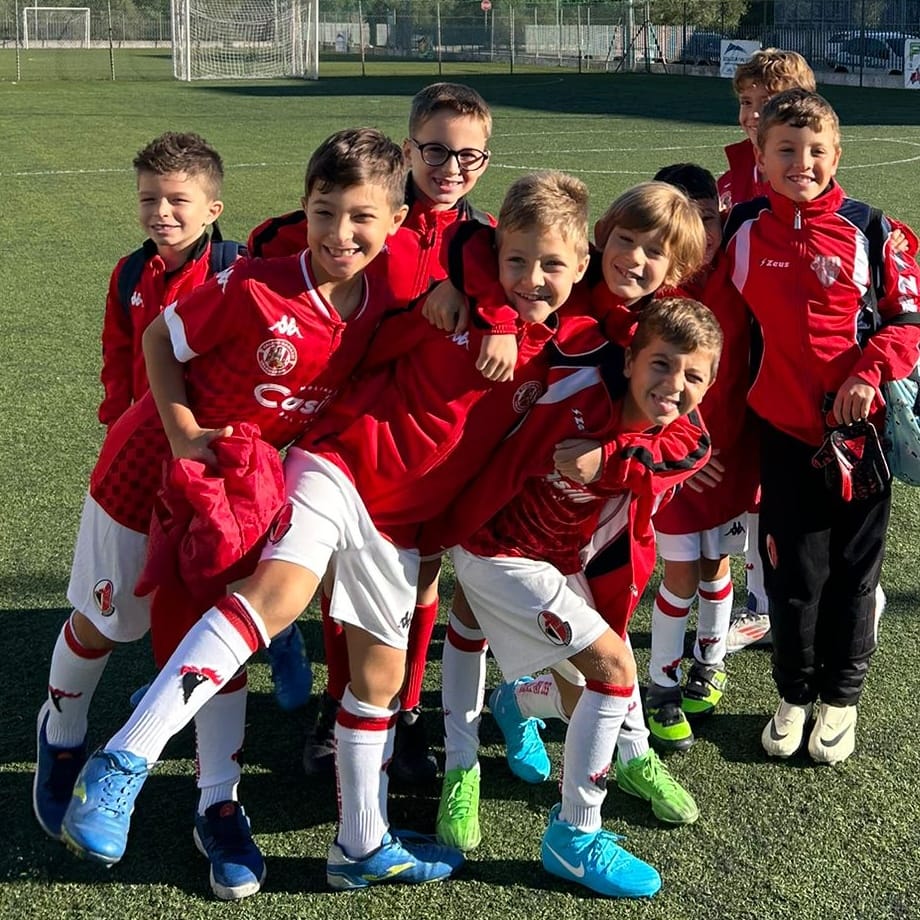 a group of young children soccer players posing for a picture
