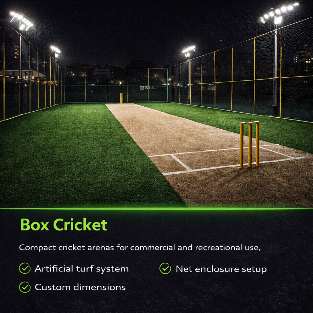 Box cricket arena with artificial turf and net enclosure under stadium lights at night.