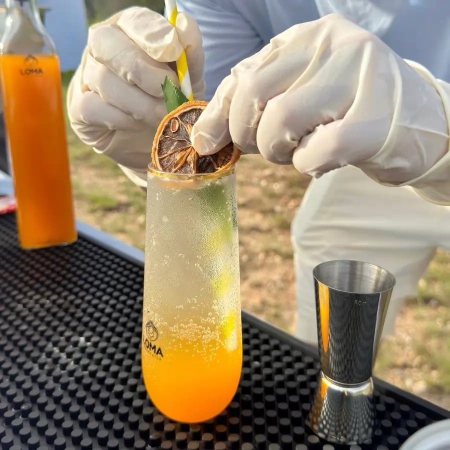 Loma Parties bartender garnishing a fresh handcrafted cocktail at a Hong Kong wedding event.