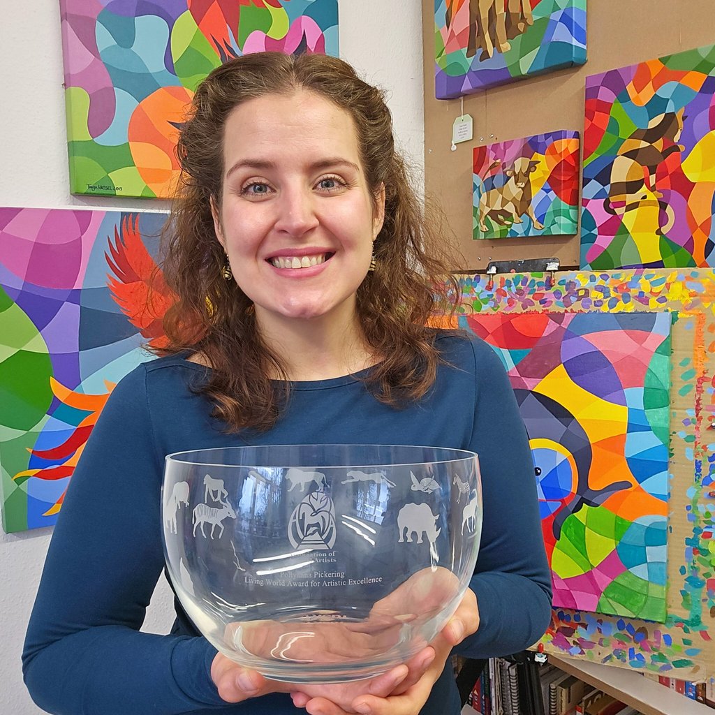 Award winning artist Tanja Hassel smiling proudly, holding Pollyanna Pickering award
