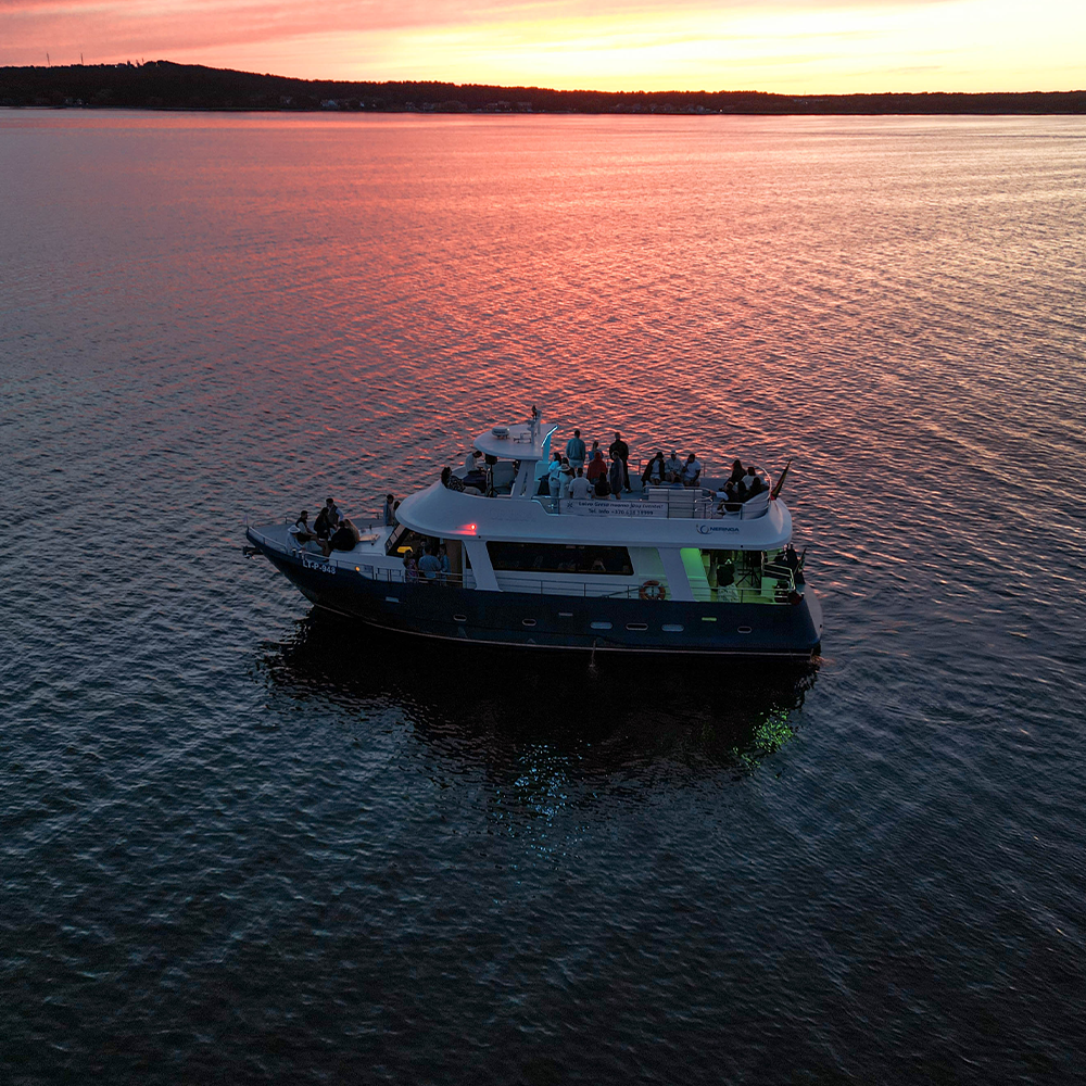 Sunset boat cruise in Nida with Curonian Lagoon views and dunes on the horizon