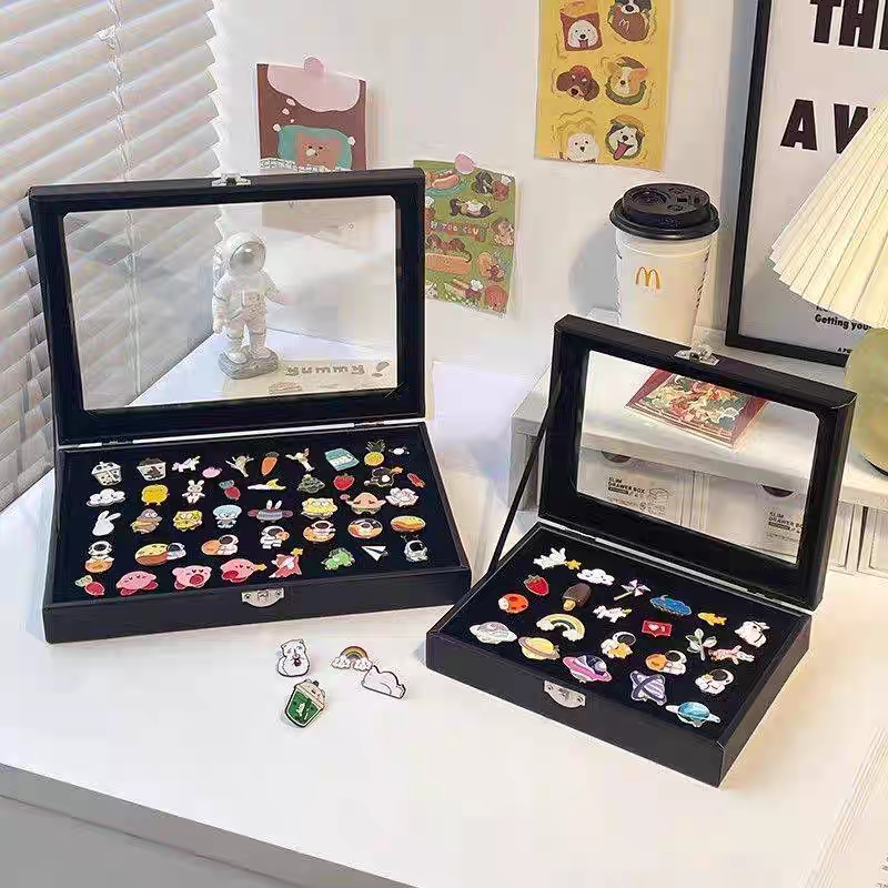 Enamel pins shown at different sizes for scale