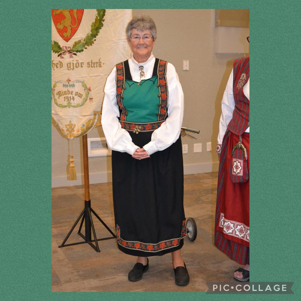 A woman in a Bunad with a green bodice
