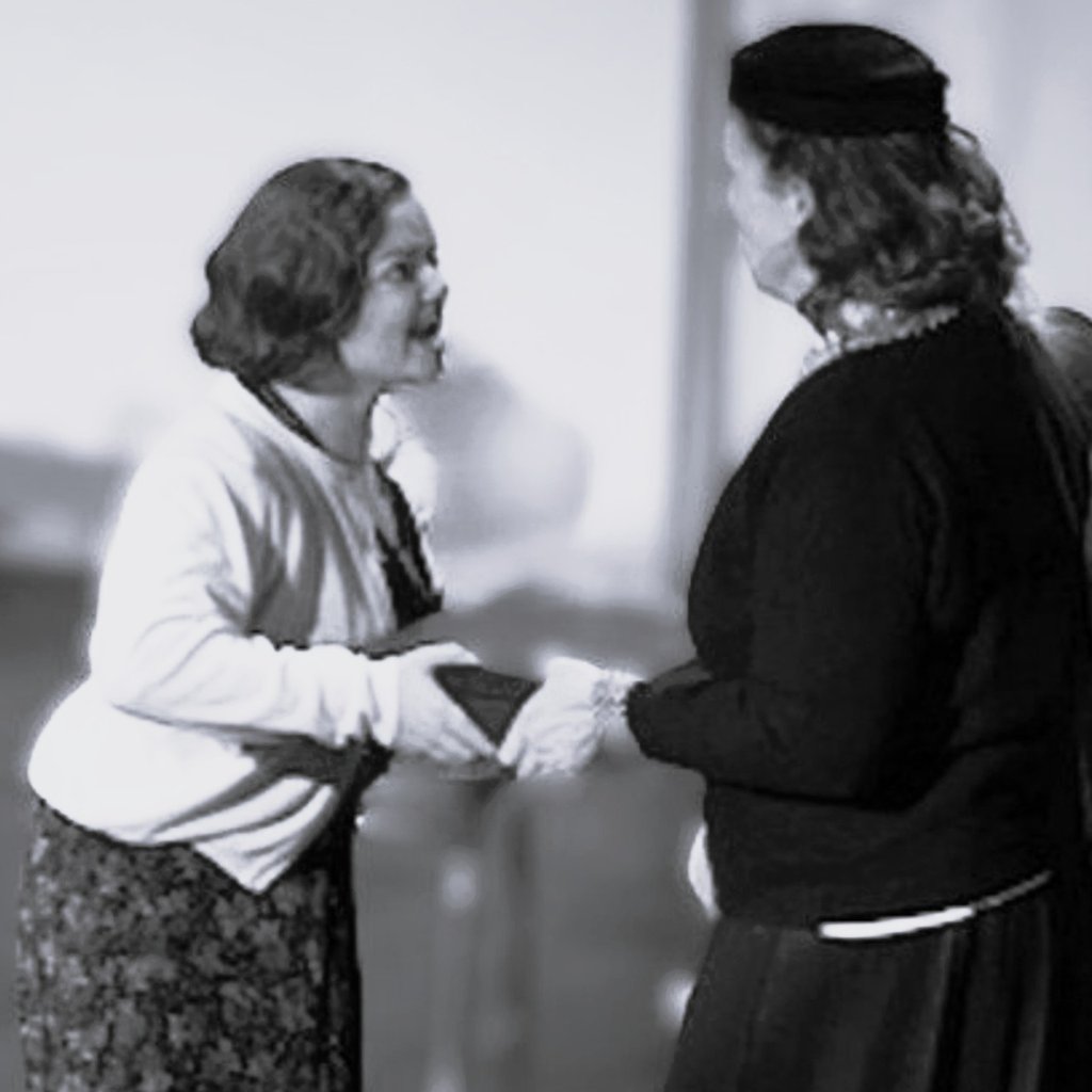 An angry Young Catherine trying to tug a box away from a woman.