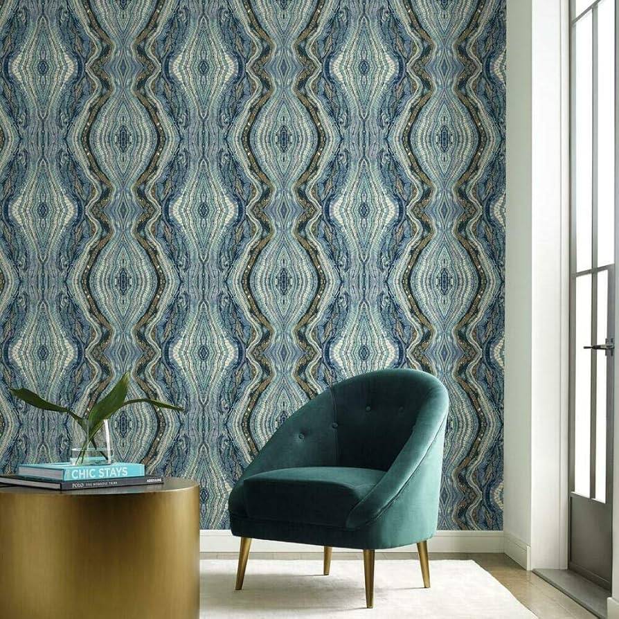 Modern living room featuring blue marbled wallpaper and a teal velvet accent chair.