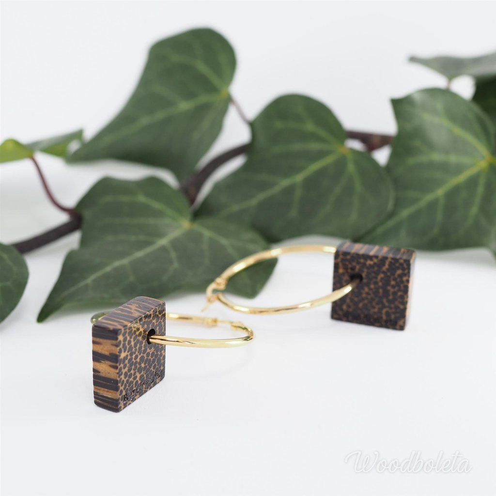 Earrings with golden rings and black palm wood cubes