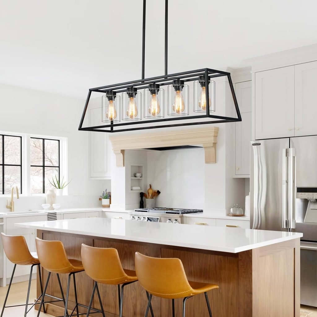Modern black cage island chandelier with Edison bulbs hanging over a white marble kitchen island.