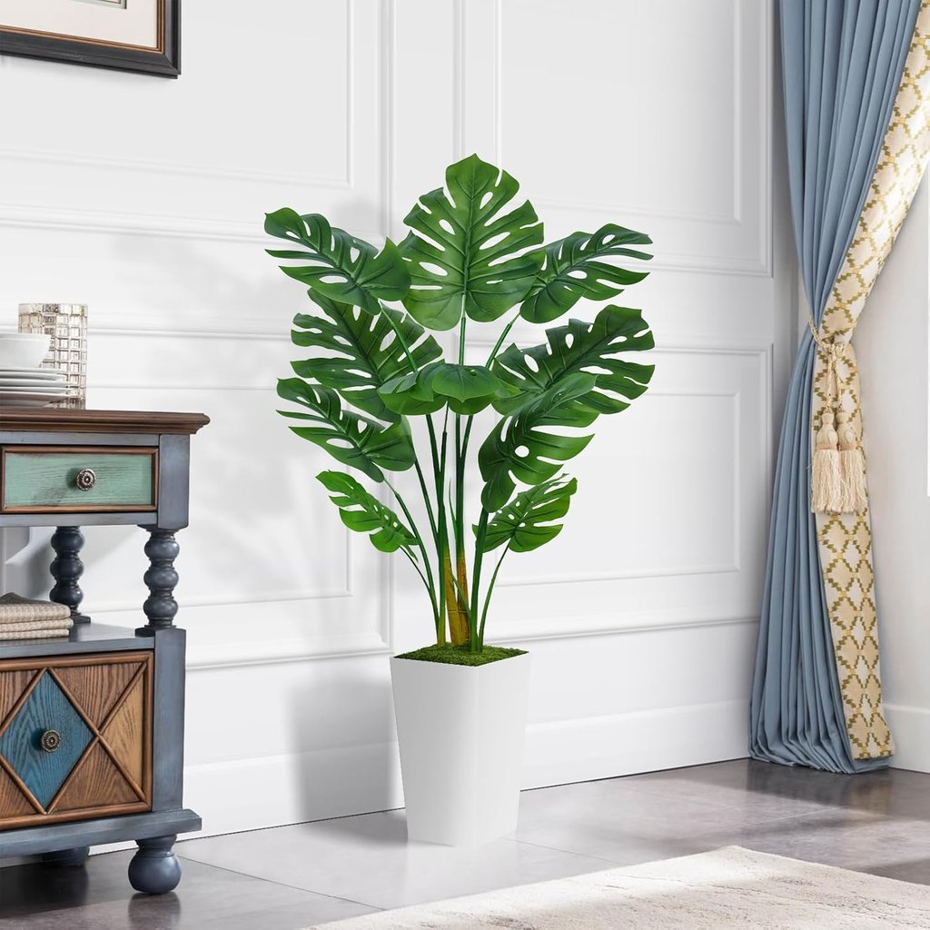 Artificial Monstera Deliciosa plant in a white pot for modern home decor.