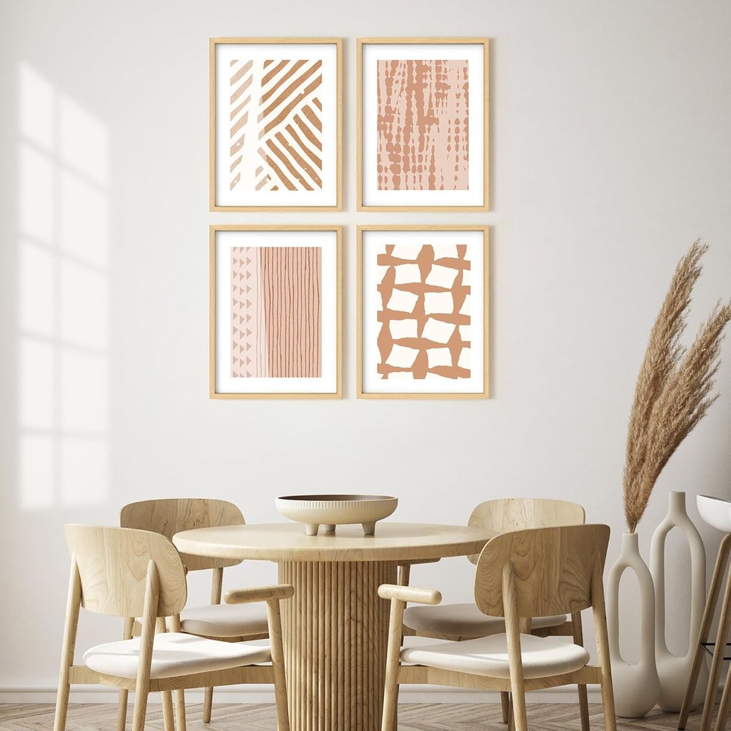 Minimalist dining room with boho abstract wall art prints and a round wooden table set.