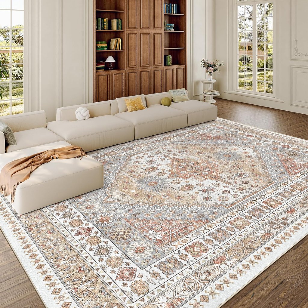 Large vintage-style area rug with intricate beige and terracotta patterns in a bright modern living room.