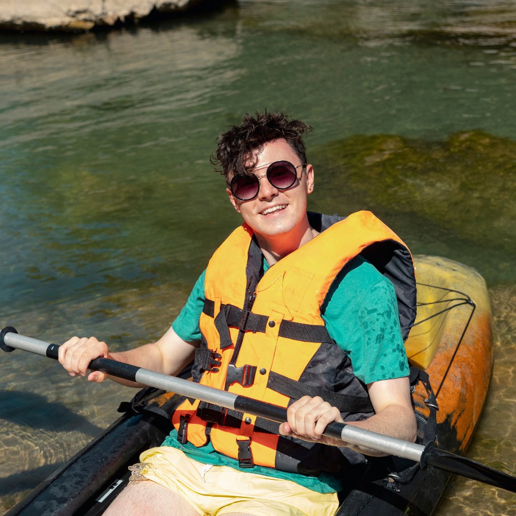 Person kayaking with UV protection in their sunglasses