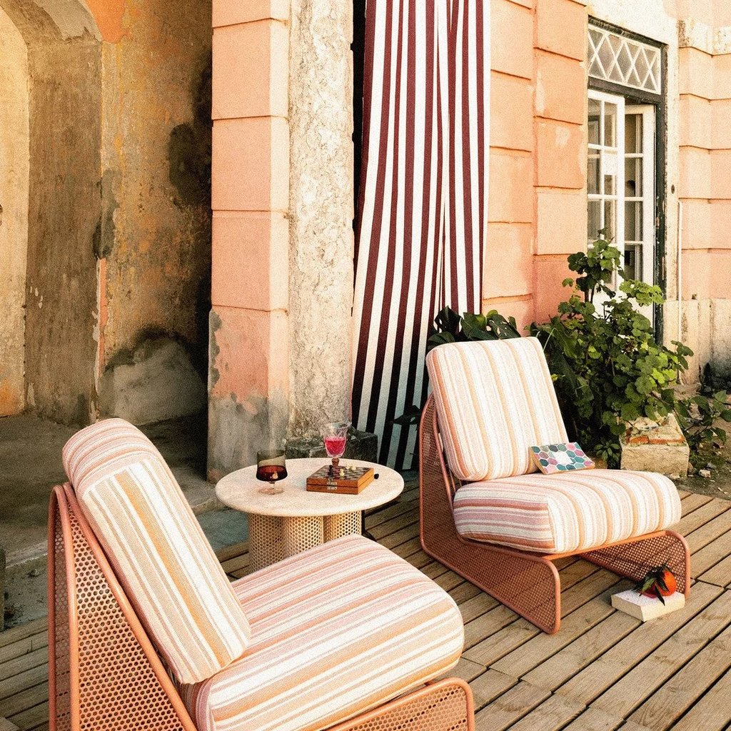 Striped outdoor cushions on lounge chairs adding softness, color and warmth to a cozy patio seating