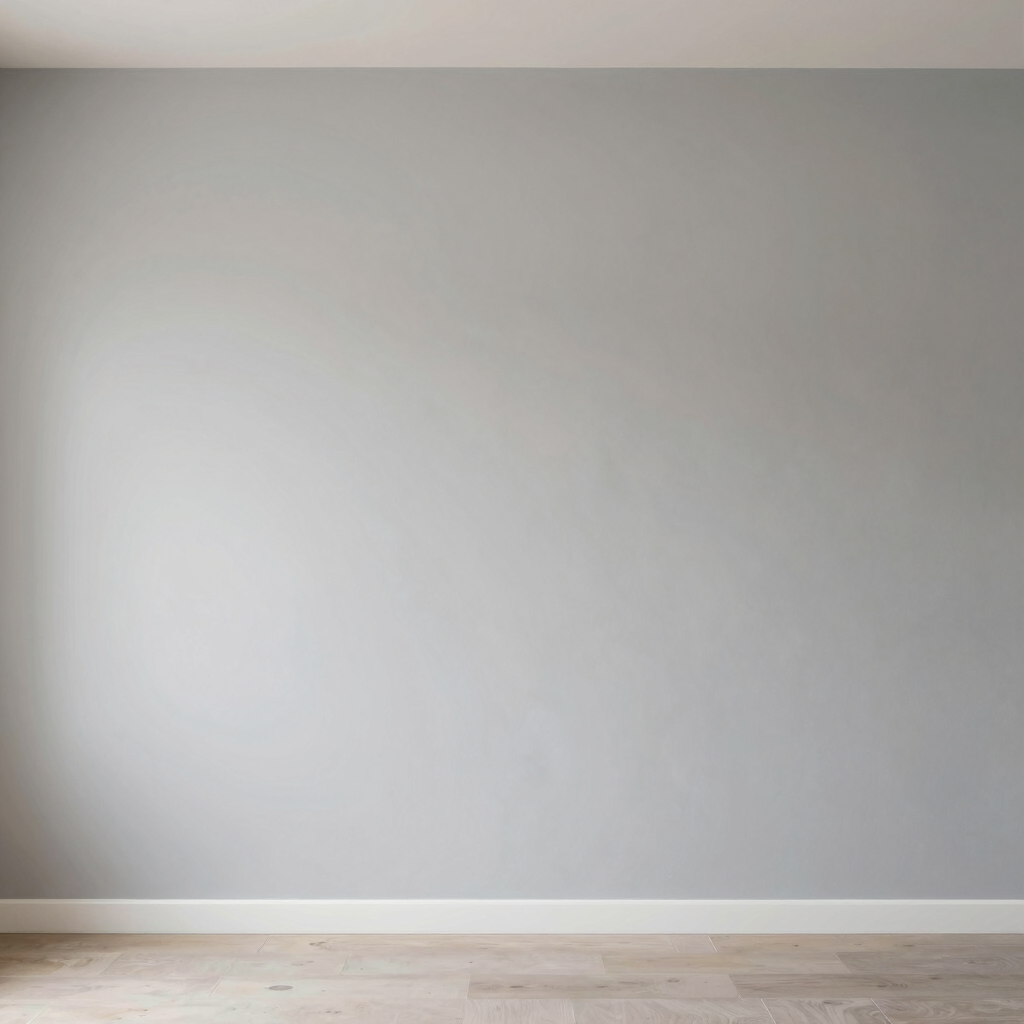 Modern construction worker applying plaster on a wall in a bright, minimalist interior.