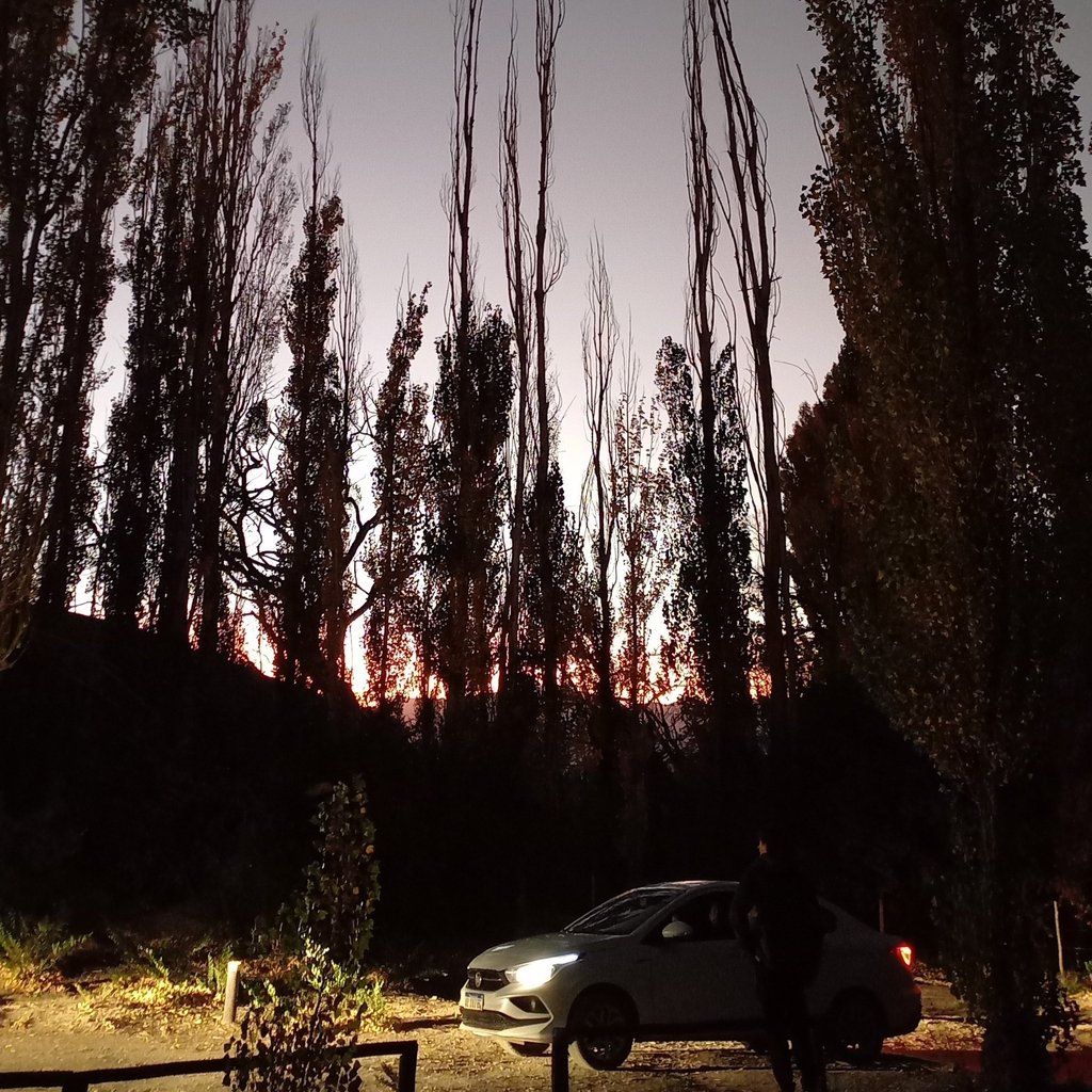 a car parked in a driveway with a car parked in front of it