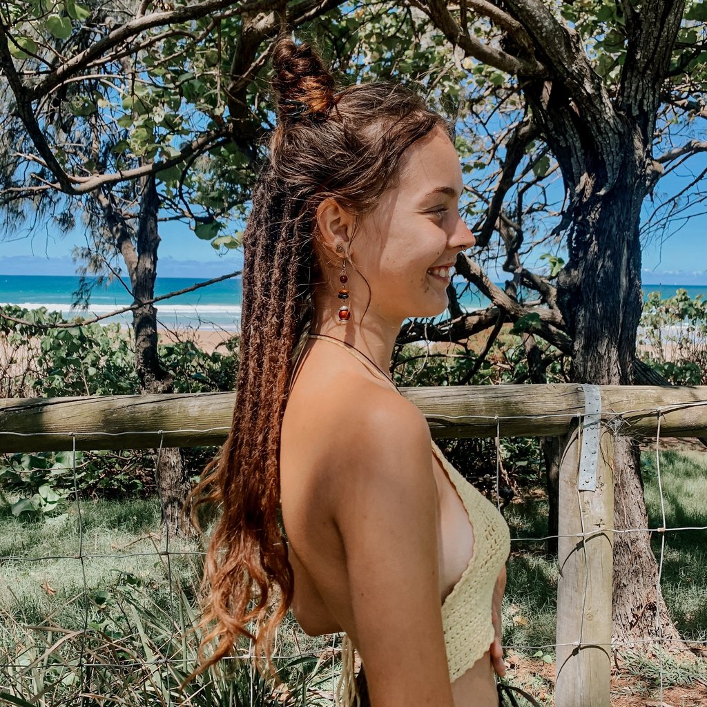 a woman at the beach with dreadlocks