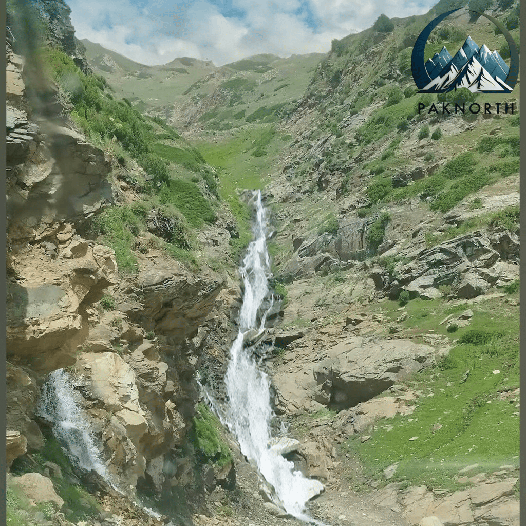 Water stream flowing down by a mountain 