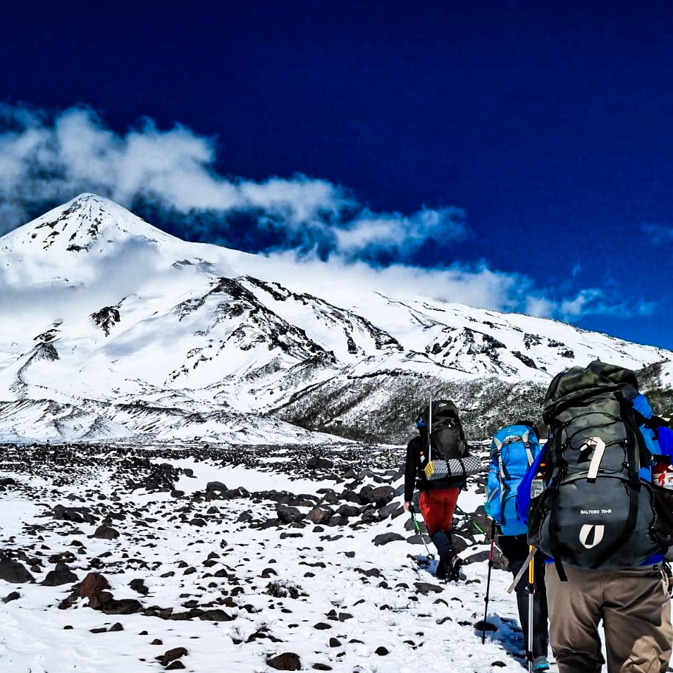 a group of people walking up a snowy mountain