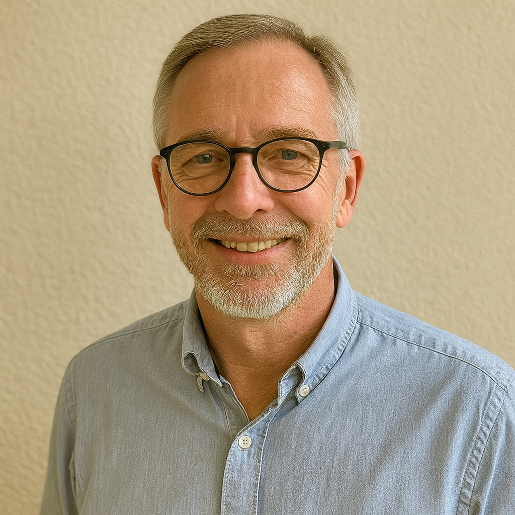 a man with glasses and a blue shirt