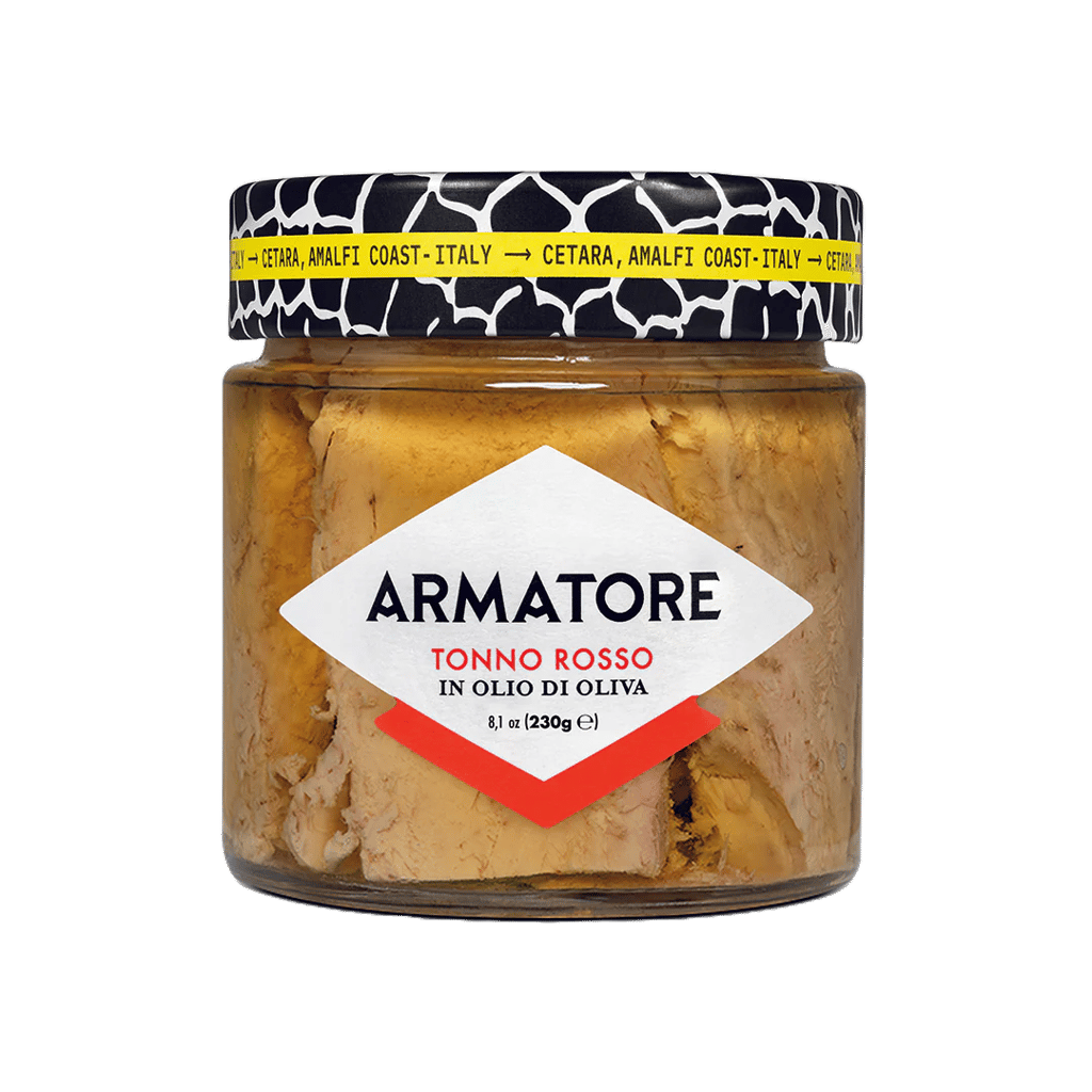 a jar of food with a cat sitting on a table