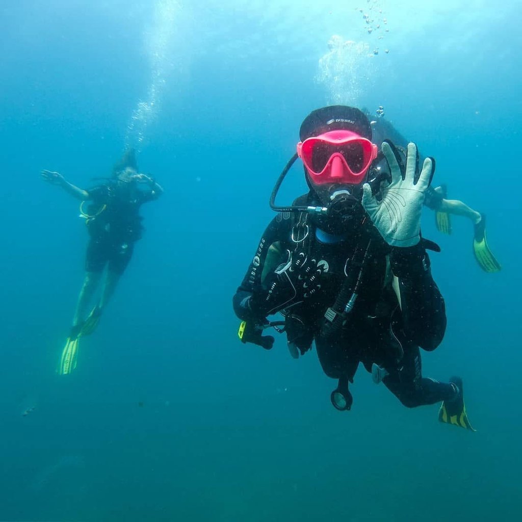 a person in a scuba suit and scuba goggles